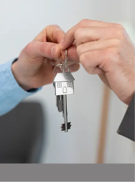Hand holding house keys